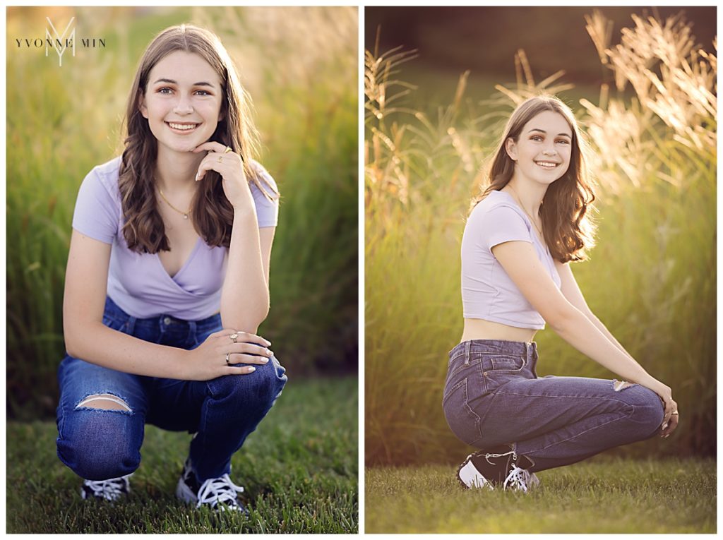 Senior girl sitting in front of wild grass at her senior shoot with Yvonne Min.