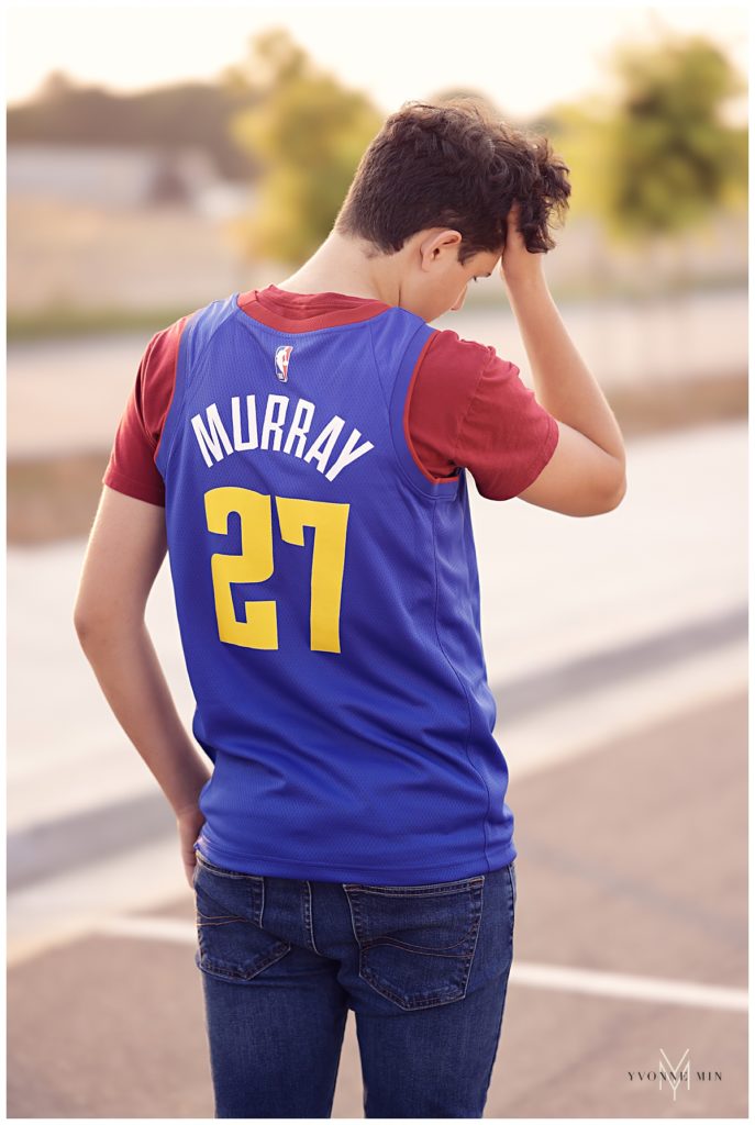High school senior boy wearing a Denver Nuggets jersey during his photo shoot.