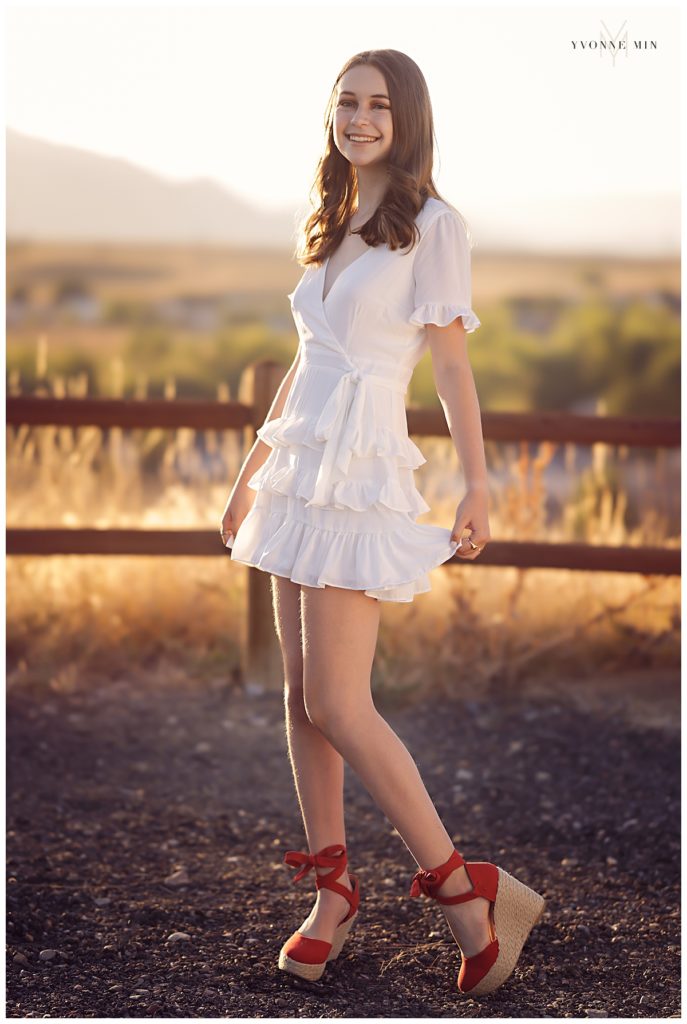 High school senior girl in a white dress at Oerman Rosch trailhead in Superior, Colorado with Yvonne Min.