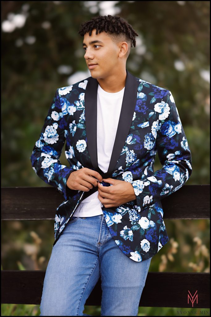 Ezekiel wears a floral jacket at his senior photoshoot in Thornton, Colorado.