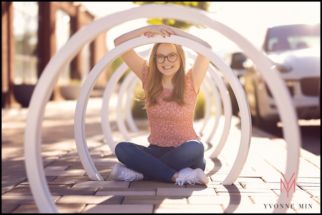 Adilyn poses among some newly installed bike racks for her senior photos in Westminster, Colorado.