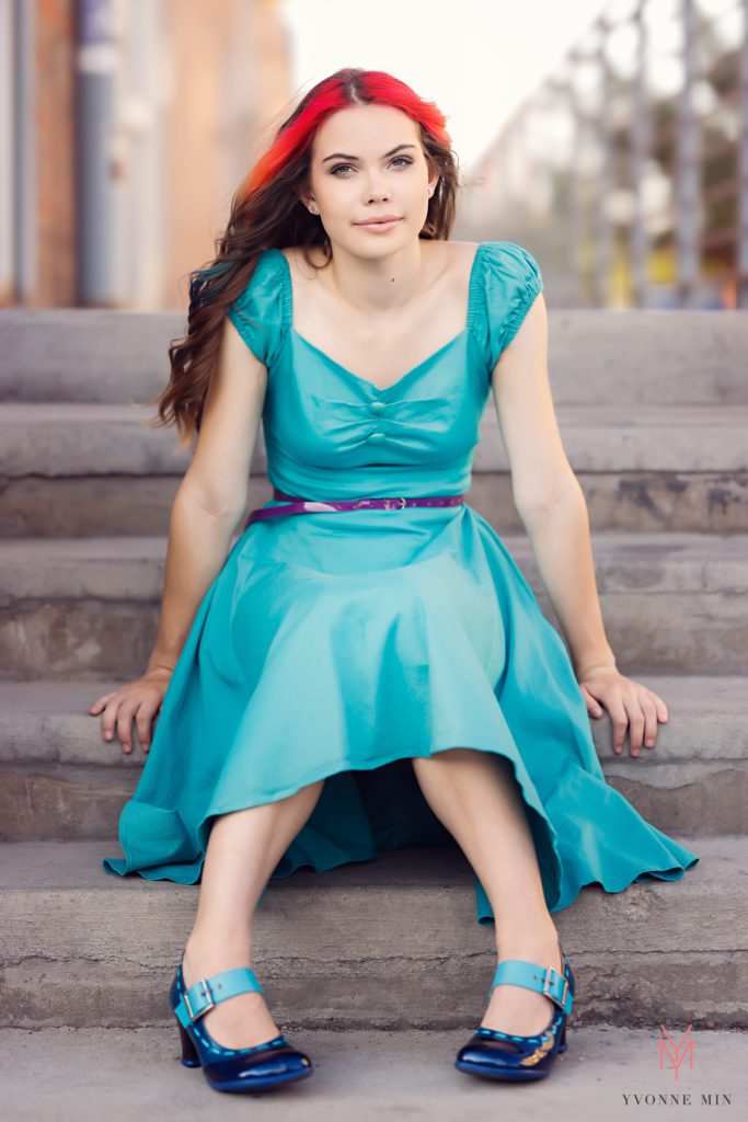 A high school senior girl poses for her senior photos in Denver with Yvonne Min Photography.