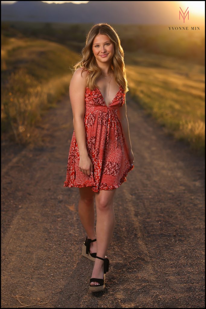 Bailey walks in the sunset light at her senior photoshoot at Purple Park in Superior, Colorado.