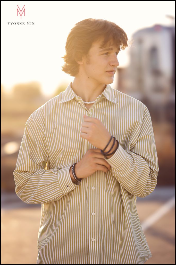 Conor adjusts his watch during his senior photoshoot which took place in Old Town East Lake in Thornton, Colorado.