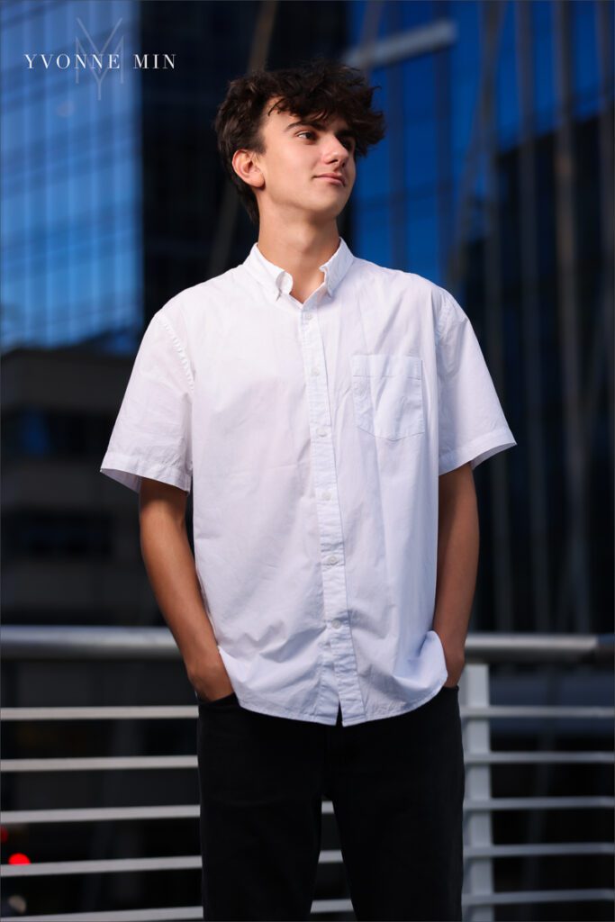 An off camera flash photograph of a high school senior boy in Lodo Denver taking during his high school senior photoshoot.