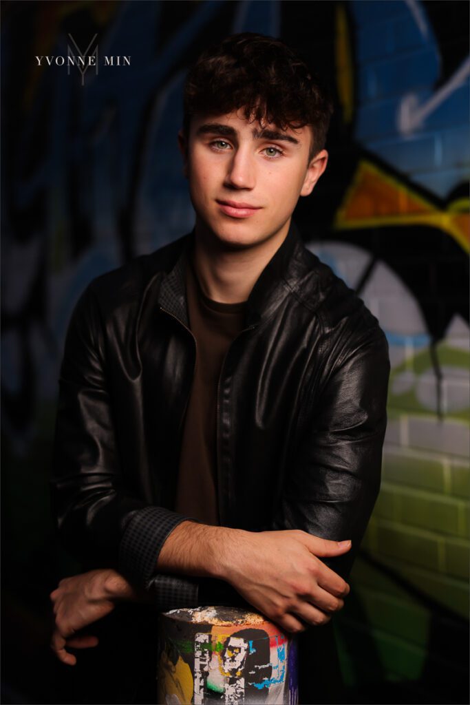An OCF shot of a senior boy from Stargate High School taken by Yvonne Min Photography in the RiNo district of downtown Denver.