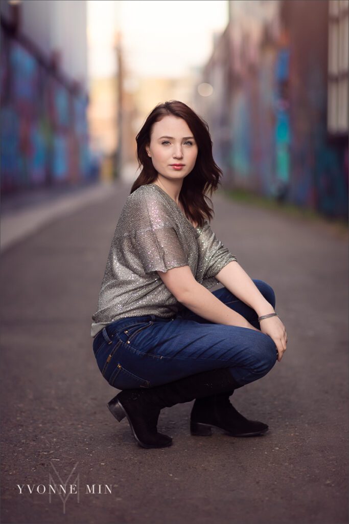 A high school senior girl player from Legacy High School poses for his senior photos in RiNo Art District, Denver with Yvonne Min Photography.
