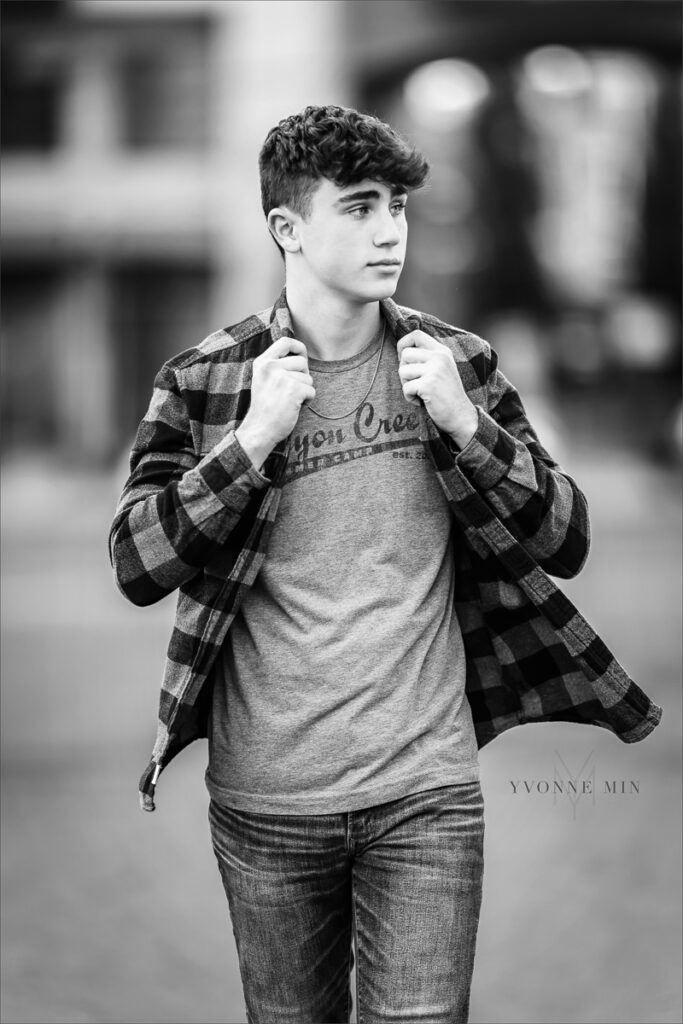 A black and white photos of a senior boy from Stargate High School from his senior photoshoot in the RiNo Art District in downtown Denver with Yvonne Min Photography.