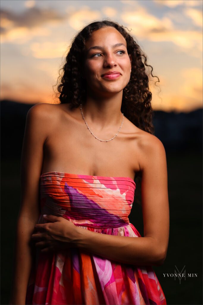 An off camera flash (OCF) picture of a senior girl from East High School taken on the Millennium Bridge in downtown Denver at her senior photoshoot with Yvonne Min Photography.