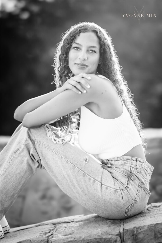 A black and white senior picture of an East High School student taken in downtown Denver by Yvonne Min Photography.