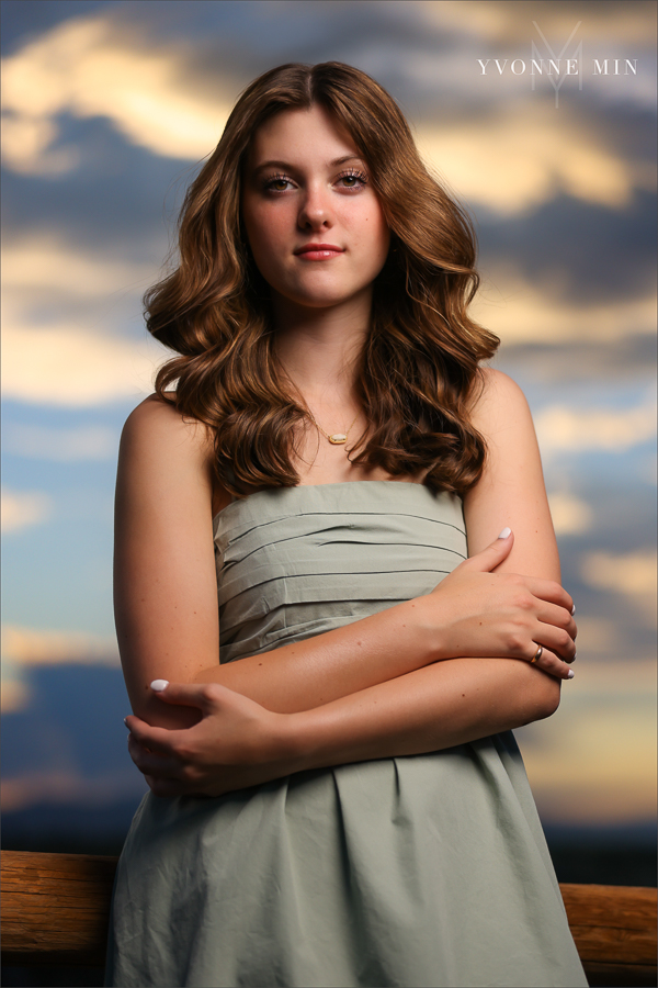 A Stargate High School senior girl poses in front of the sunset at her senior photoshoot with Yvonne Min Photography at Purple Park in Superior, Colorado.