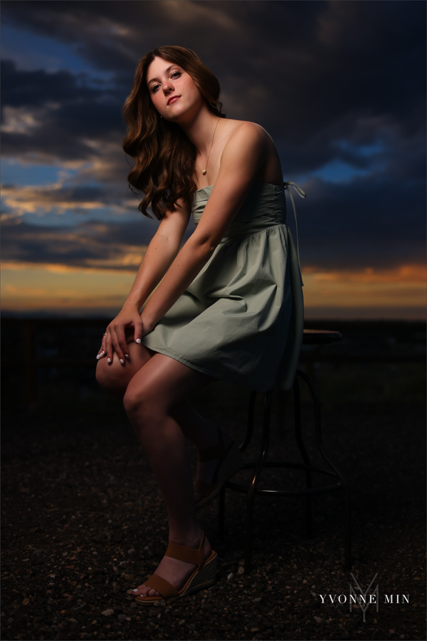 A Stargate High School senior girl poses in front of the sunset at her senior photoshoot with Yvonne Min Photography at Purple Park in Superior, Colorado.