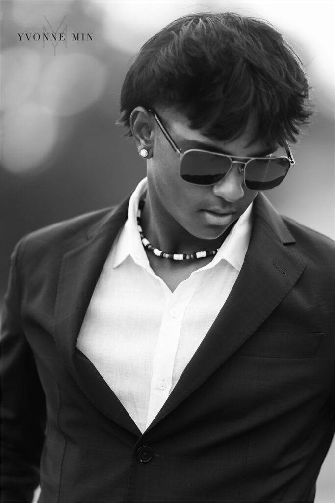 A black and white senior picture of a Stargate student wearing a suit taken at Majestic Views Park in Arvada, Colorado by Yvonne Min Photography.