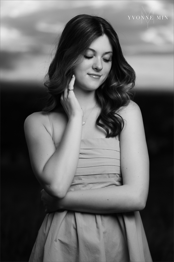 A Stargate High School senior girl poses in front of the sunset at her senior photoshoot with Yvonne Min Photography at Purple Park in Superior, Colorado.