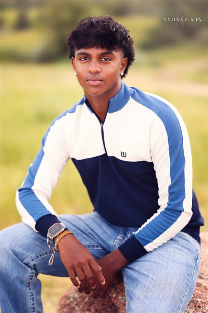 A senior portrait of a Stargate High School boy posing on a trail in Majestic Views Park, Arvada, Colorado taken by Yvonne Min Photography.