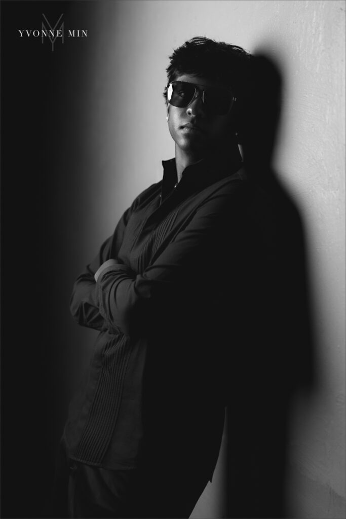 A black and white senior picture of a Stargate student wearing a suit taken at Majestic Views Park in Arvada, Colorado by Yvonne Min Photography.