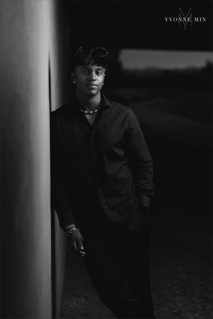 A black and white senior picture of a Stargate student wearing a suit taken at Majestic Views Park in Arvada, Colorado by Yvonne Min Photography.