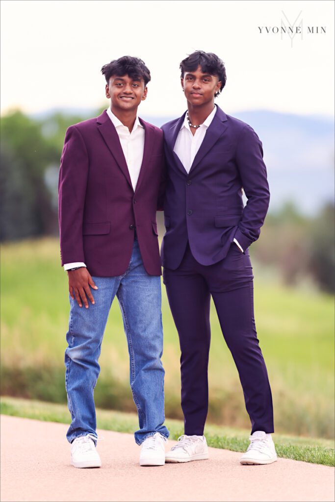 Two brothers pose together at a senior pictures session in Majestic Views Park, Arvada, Colorado taken by Yvonne Min Photography.