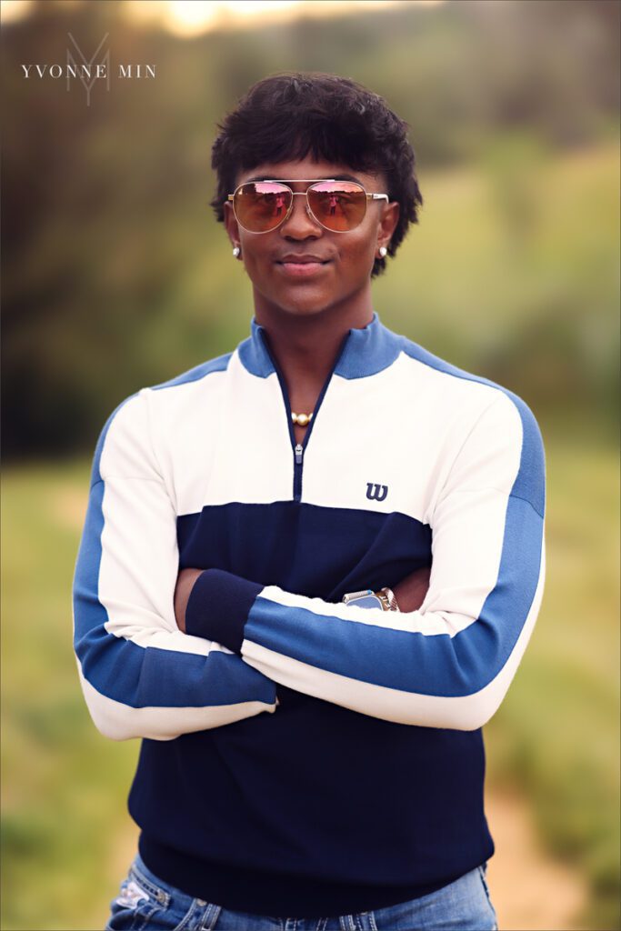 A senior portrait of a Stargate High School boy posing on a trail in Majestic Views Park, Arvada, Colorado taken by Yvonne Min Photography.