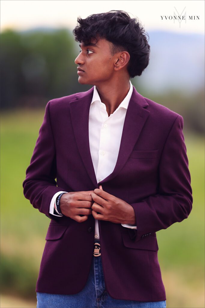 A senior portrait of a Stargate High School boy posing on a trail in Majestic Views Park, Arvada, Colorado taken by Yvonne Min Photography.