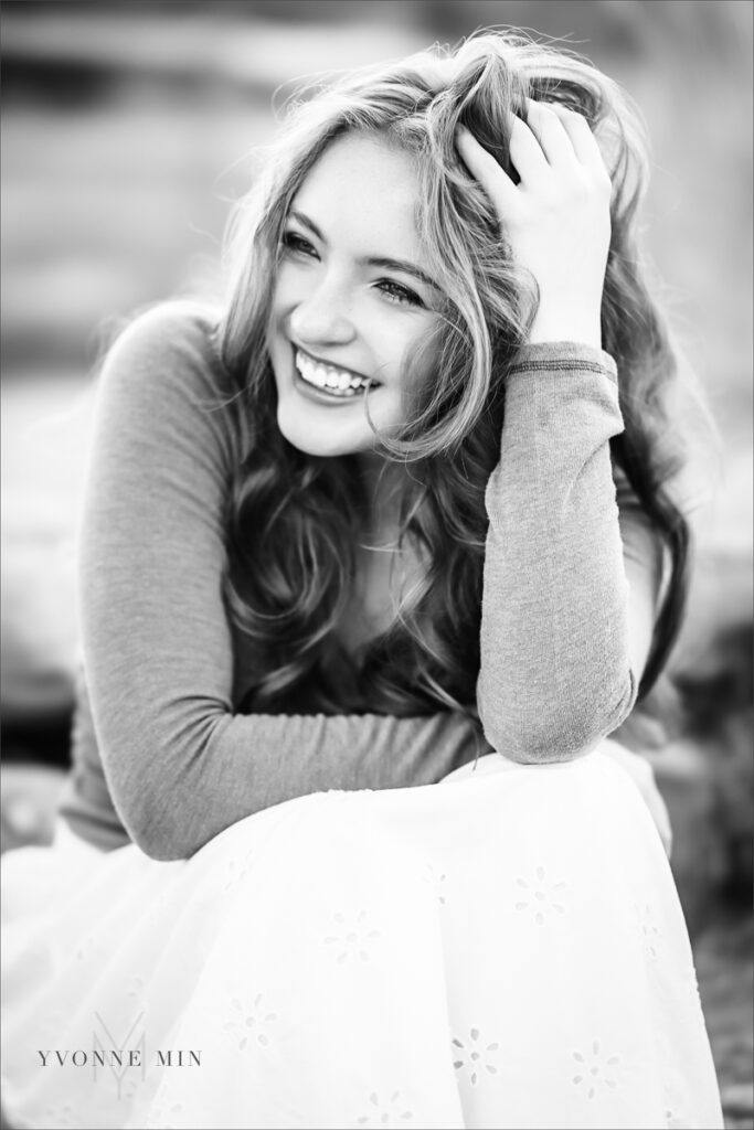 A Stargate High School senior student poses on the bridge at South Mesa Trailhead with Yvonne Min Photography in a black and white senior picture.