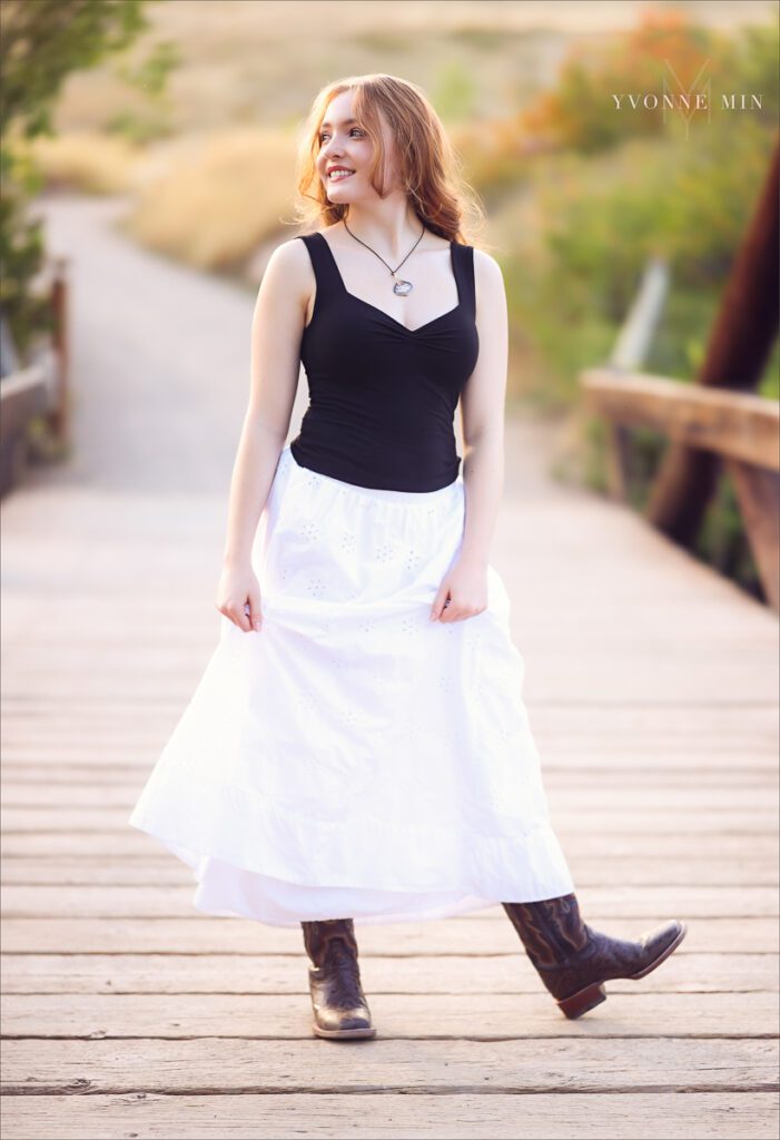 A Stargate High School senior student poses on the bridge at South Mesa Trailhead with Yvonne Min Photography.