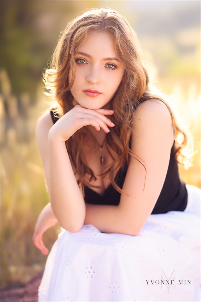 A sunset senior picture taken of a Stargate High school student with long red hair taken by Yvonne Min Photography at South Mesa.