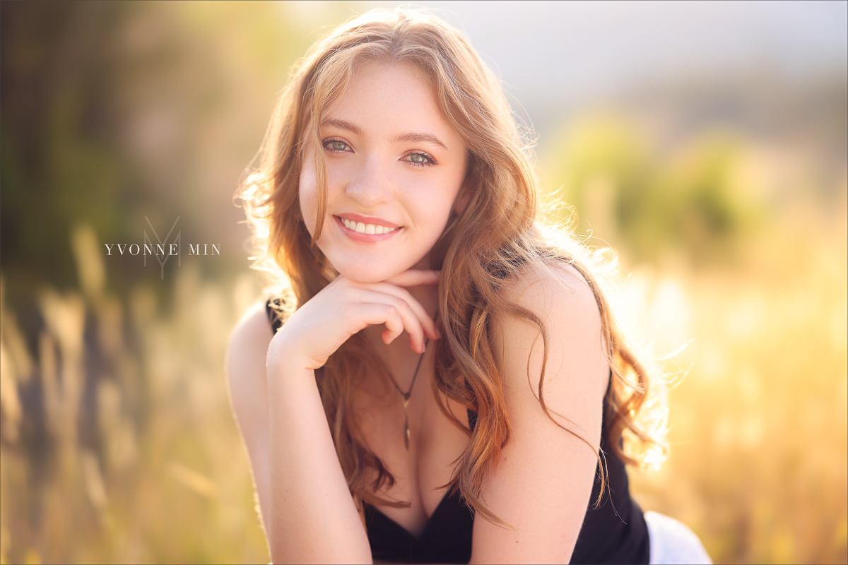 A Stargate High school student sits on a rock at South Mesa during her senior photoshoot with Yvonne Min Photography.