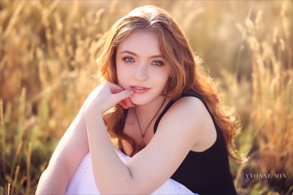 A Stargate High school student sits on the ground at South Mesa during her senior photoshoot with Yvonne Min Photography.