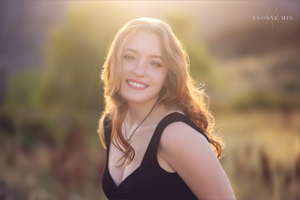 A sunset senior picture taken of a Stargate High school student with long red hair taken by Yvonne Min Photography at South Mesa.