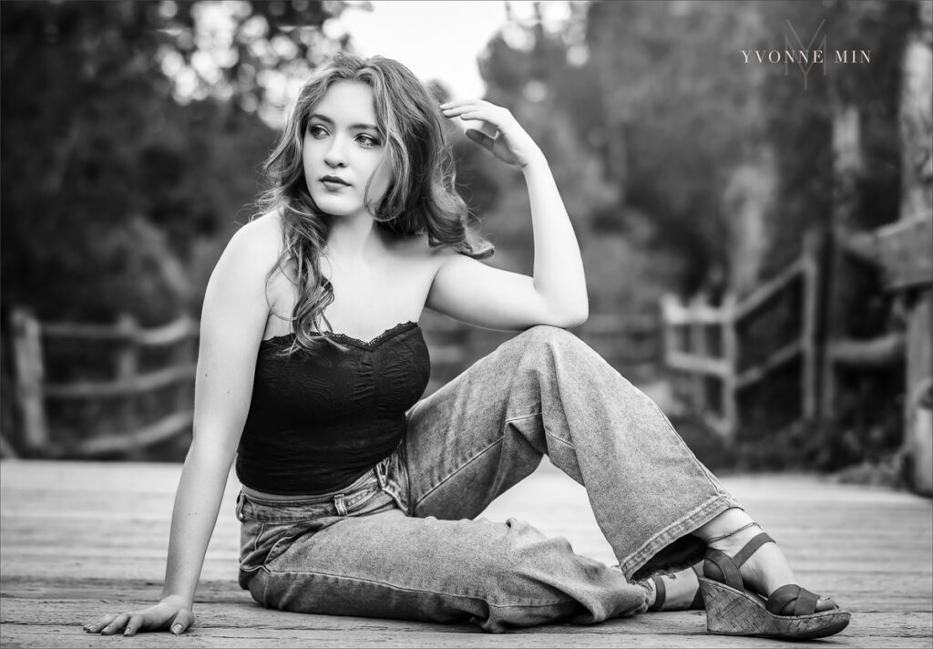 A high school senior from Stargate High School poses on a bridge at her senior photoshoot at South Mesa with Yvonne Min Photography.