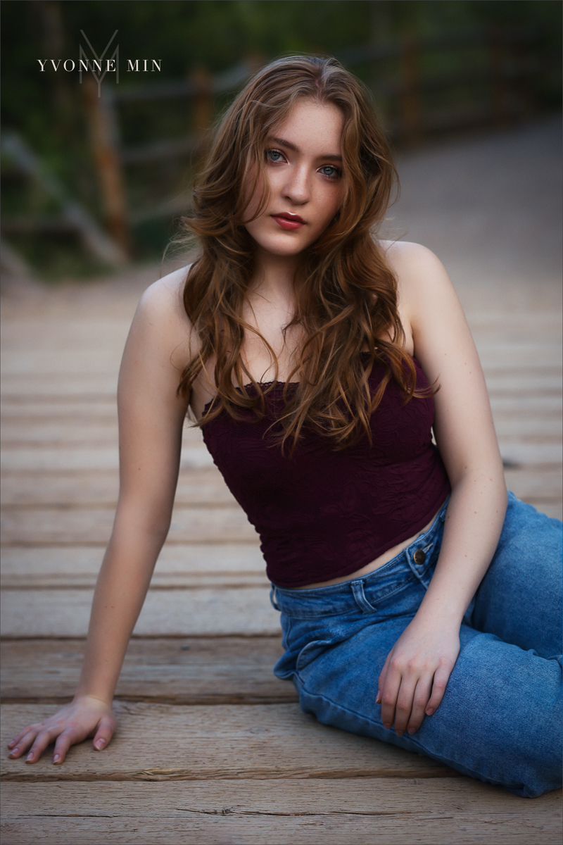 A high school senior from Stargate High School poses on a bridge at her senior photoshoot at South Mesa with Yvonne Min Photography.