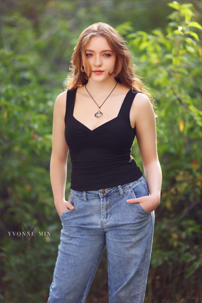 A high school senior from Stargate High poses in a black shirt at her senior photoshoot session with Yvonne Min Photography at South Mesa Trailhead.