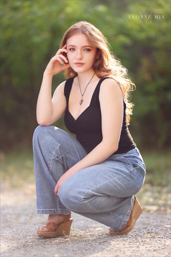 A high school senior from Stargate High poses in a black shirt at her senior photoshoot session with Yvonne Min Photography at South Mesa Trailhead.