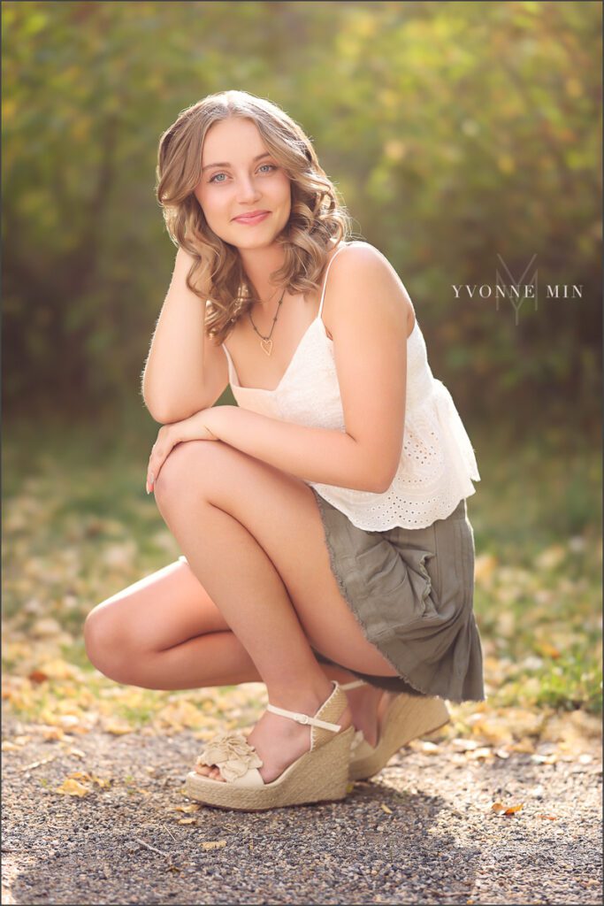 A high school senior girl from Jefferson Academy poses at her senior photoshoot at South Mesa Trailhead outside Boulder with Yvonne Min Photography.