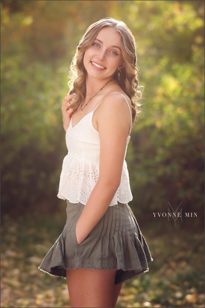 A high school senior girl from Jefferson Academy poses at her senior photoshoot at South Mesa Trailhead outside Boulder with Yvonne Min Photography.
