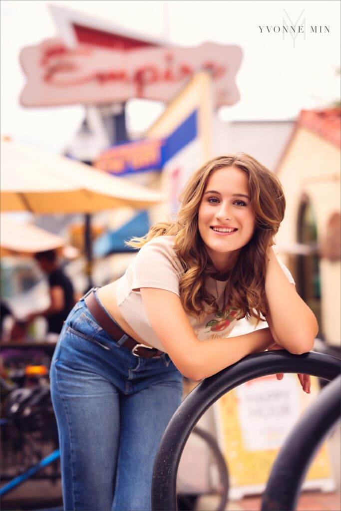 A high school senior picture of a student from Legacy High School posing in front of Empire restaurant in downtown Louisville, Colorado with Yvonne Min Photography.