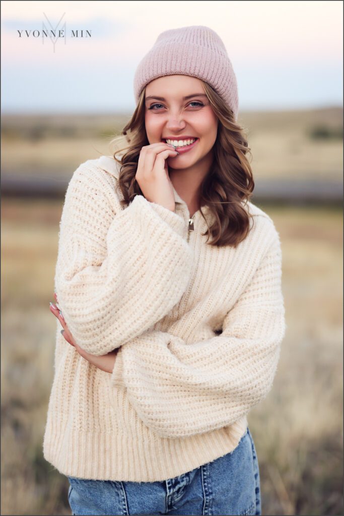 A high school senior girl from Jefferson Academy poses at her senior photoshoot with Yvonne Min Photography at Flatirons Vista outside Boulder.