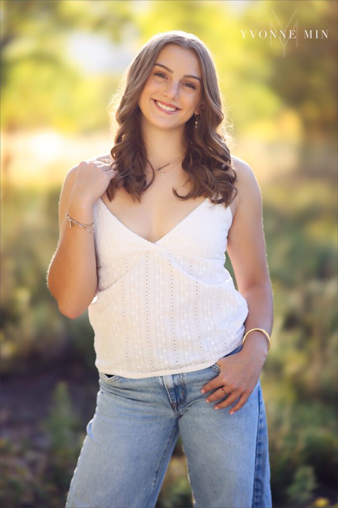 A Legacy High School senior girl poses during her senior photoshoot with Yvonne Min Photography at South Mesa Trailhead outside Boulder.